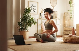 a woman sitting on the floor with a laptop and a laptop
