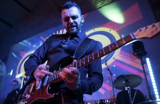 Guitarist giving an intense solo during a high-energy wedding performance