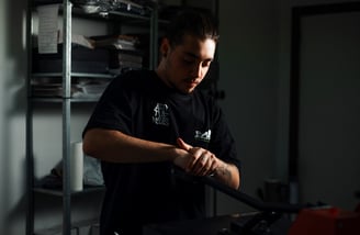 a man in a black shirt is holding a baseball bat