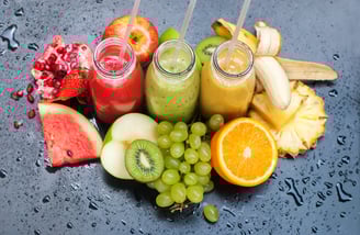 a variety of fruits and juices on a table