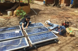 Locals assembling a solar PV rack, to be used to power a submersible DC water pump