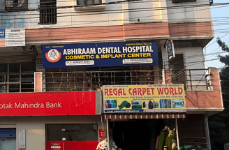 a building with a sign that says abhiraam dental hospitals