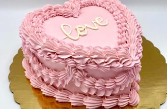 a pink heart shaped cake with a heart shaped cake