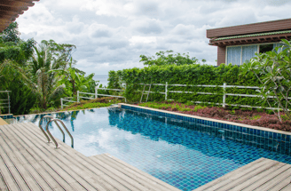 Beautiful setting with wood-planked deck surrounding a zero-edge square pool