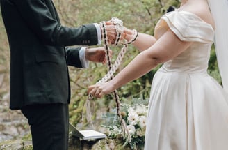 a man and woman holding hands and a rosary