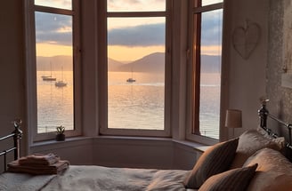 The bed at Gourock Seaview Holiday Let with the bed and a view of the sea