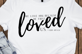 a t - shirt with a white shirt and jeans with 1 John 4:19 KJV on it the front of the t-shirt