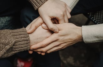 a group of people holding hands together