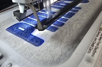 embroidery machine stitching glitter tackle twill letters onto fabric - San Antonio, TX