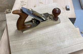 Lie Neilson smoothing plane on solid oak panel