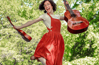 Musicienne sautant dans les air avec ukulele et guitare / a woman in red dress jumping in the air