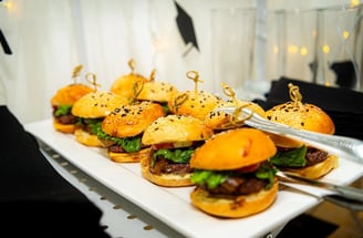 a plate of mini sandwiches with cheeseburger