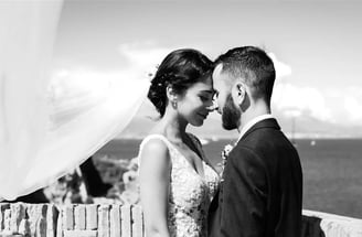 Black and white wedding photo with bride’s veil flying by the sea – BonjourMrsBride