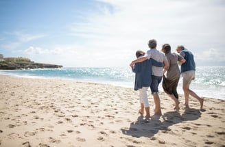 a family of three people walking on a beach