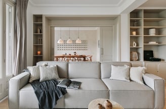 Elegant living room with bespoke wall installation, neutral tones by SAVIA interior design