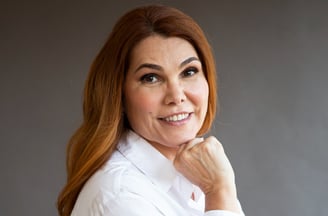a woman with red hair and a white shirt
