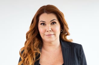 a woman in a suit and a black top
