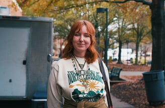 Young redheaded college woman smiling at camera.