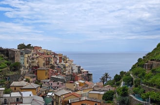 View of Manarola with mountains and sea in background