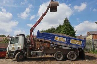 grabber about to unload top soil in stourbridge