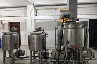 a bunch of equipment in a room to manufacture herbal oil