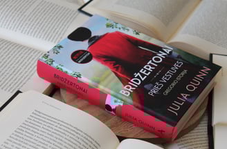 a book with a bookmark on it and a book on a table