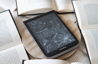 a book is sitting on a table with books and a book heartsong tjklune