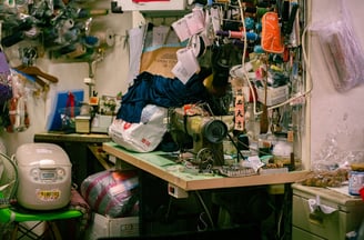 a sewing machine in a room with many items in Taiwanese market