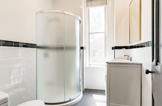 a family bathroom with a shower and a toilet