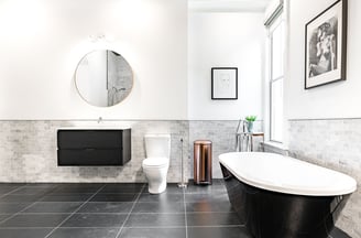 a bathroom with a bathtub and a mirror