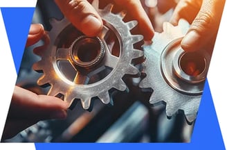 two hands holding gears and gears on a blue background