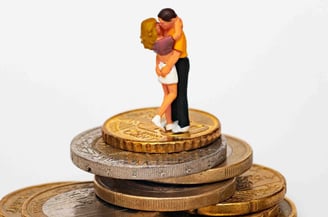 a couple kissing on top of a pile of coins