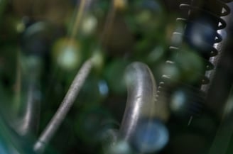 Glass pebbles with a water house in the reflection.