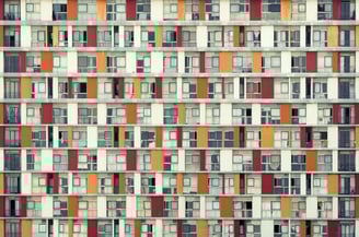 Fine art photograph by Martin Osner showing a colourful grid of apartment balconies and windows in an urban building facade