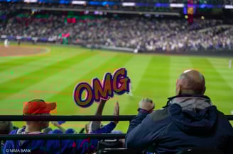 excited fans with a jose iglesias omg sign cheering the mets at citifield during nlcs game 5
