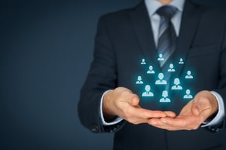 Target audience icons floating above businessperson’s hands
