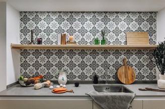 Open-plan kitchen with patterned tiles, neutral tones in Rute apartment interior design