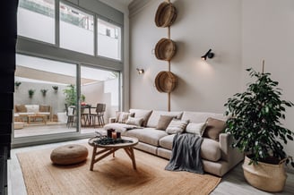 Cozy outdoor terrace with seating and sofa and natural textures in Barcelona residential design
