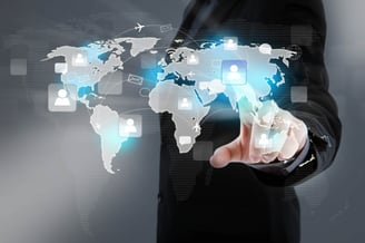 a man in a suit is holding a tablet with a map of the world