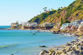 Stunning stilt houses perched at the water's edge on Malibu Beach, California.