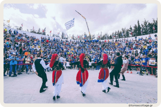 Crete Half Marathon participants at the arena, with a Cretan dancers' performance taking place