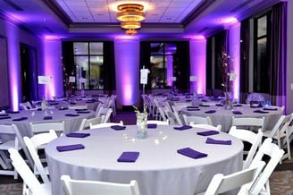 a table with purple cloth napkins and purple napkins