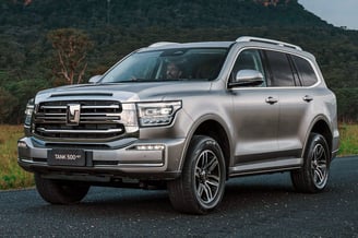 a silver suv parked on a road