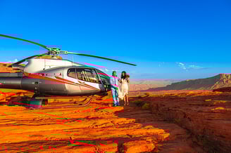 wedding couple walking by helicopter at valley of fire
