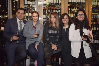 a group of people standing around a bar