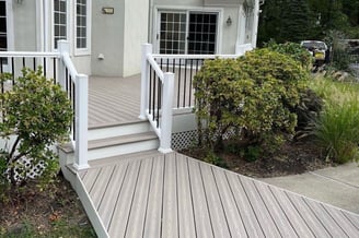 a white house with a white railing and a white railing