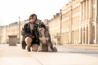 a woman in a leather jacket and a dog