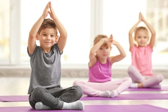 Kids performing Yoga