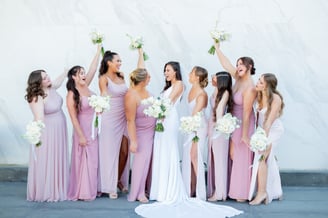 A moment captured by Los Cabos Wedding Films at the Garza Blanca Hotel in San José del Cabo: Bridesmaids raising their floral
