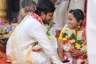 a man and woman in traditional indian wedding attire